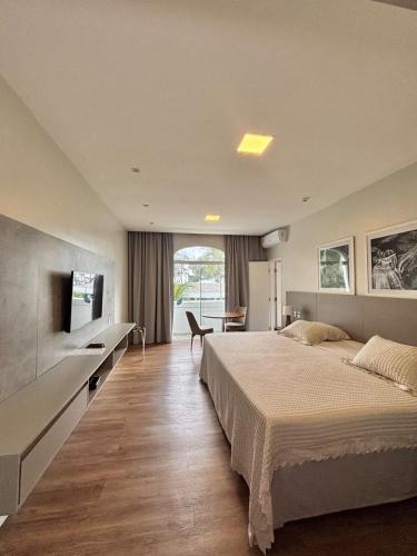 a bedroom with a large bed and a television at Blue Tree Premium São Luis in São Luís