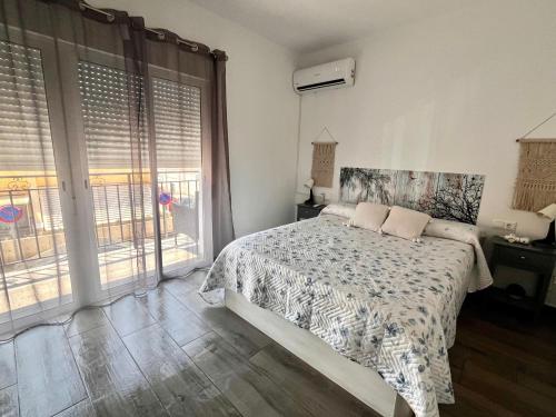 a bedroom with a bed and a large window at Horrillo San José in San José