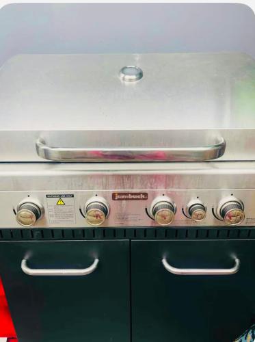 a stove top with a pan on top of it at Nyumbani place that means home in Sydney