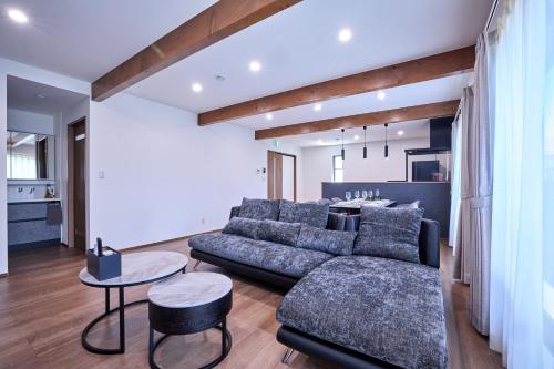a living room with a couch and a table at Fuji no Warabi in Fujikawaguchiko