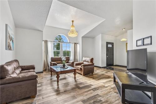 a living room with a couch and a tv at Relaxing Family Retreat in the Heart of Sebastian home in Sebastian