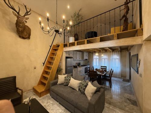 a living room with a couch and a dining room at Apolo en ValQuirico in Santeagueda
