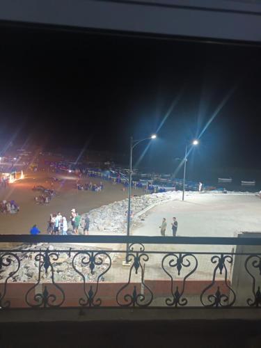 a view of a beach at night from a balcony at Résidence nissou in Jijel
