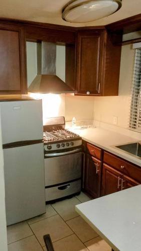 a kitchen with a stove and a white refrigerator at central in Ensenada