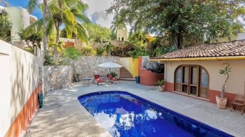 a swimming pool in the backyard of a house at Las Olas Litibu Bungalow By The Sea in Higuera Blanca
