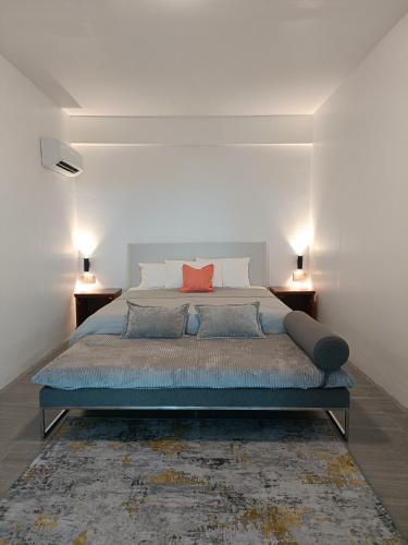 a bedroom with a large bed with a red pillow at Panoramic View & Spacious with Swimming Pool Aza Sunset Villa 1 in Langkawi Intl