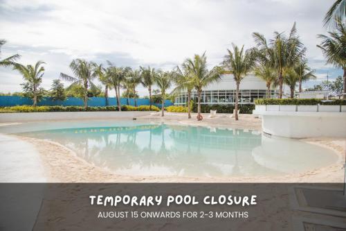 a pool at a resort with palm trees at Minimalist Spot for Couples with PS4, Netlix and Instax in San Fernando