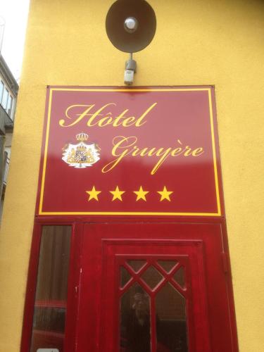 a sign over a red door with stars above it at Sveriges minsta Hotell! Hôtel Gruyère in Landskrona
