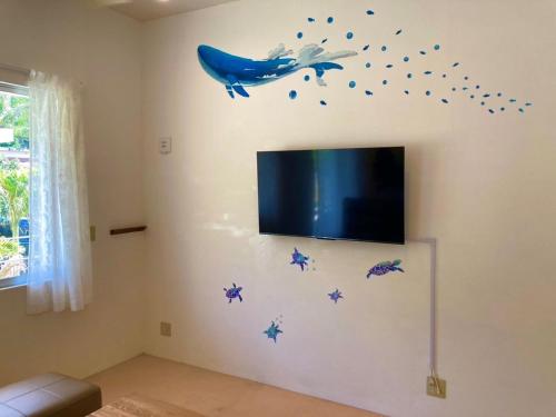 a living room with a whale and stars on the wall at Nico House C - Vacation STAY 07511v in Kabira