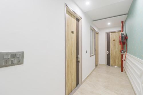 an empty hallway with a door and a room at Hotel O Citywalk in Zirakpur