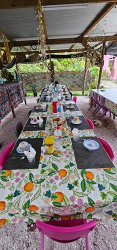 a long table with plates of food on it at Tiapaa Village in Maupiti
