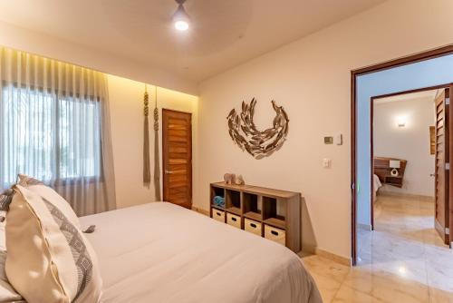 a bedroom with a bed and a mirror at Luxury Ground Floor MarinaView-Pool-Gym-Paddleboard in Puerto Aventuras