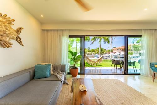 a living room with a couch and a table at Luxury Ground Floor MarinaView-Pool-Gym-Paddleboard in Puerto Aventuras
