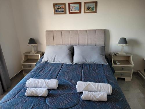 a bedroom with a bed with two towels on it at Rincon de Mayo in Tandil