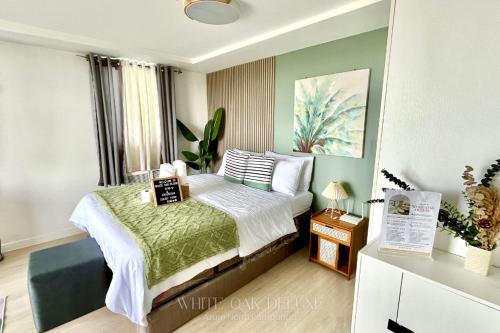 a small bedroom with a bed and a window at Entire 1BR Queen Bed with Spacious Beach View Balcony in San Fernando