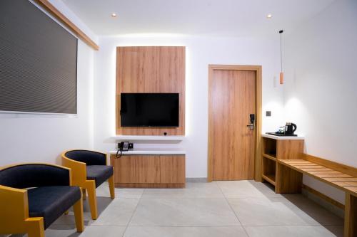 a waiting room with a flat screen tv on a wall at Blue Moon Alleppey in Alleppey