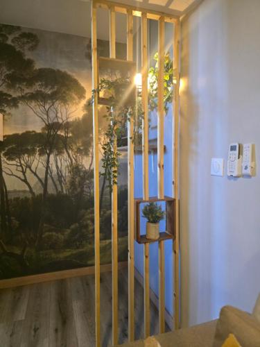 a room with a large painting on the wall at Appartement Belsol Ambiance tropicale et détente in Sada