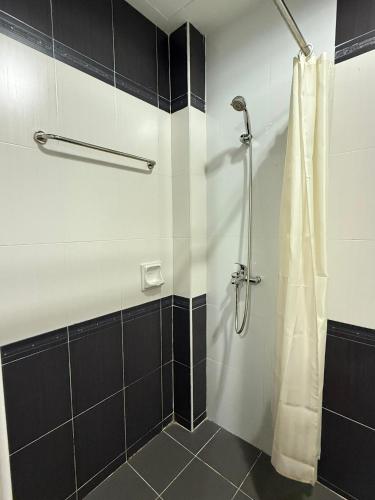 a bathroom with a shower with a shower curtain at Puteri Bay Hotel in Melaka