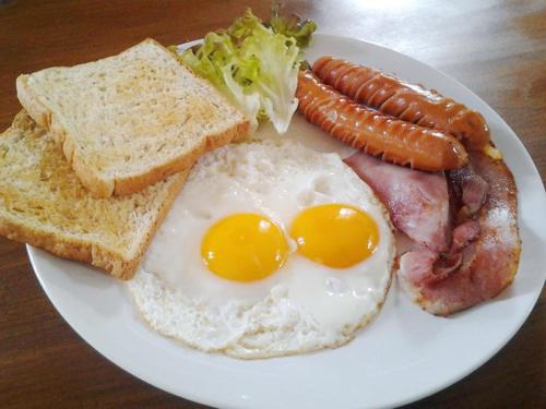 a plate of breakfast food with eggs and toast at SELA Bungalow and Italian Restaurant in Koh Rong