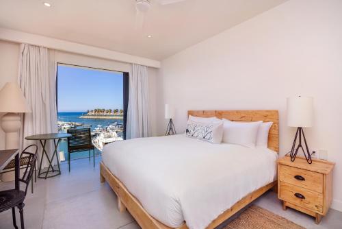a bedroom with a bed and a view of the ocean at Hotel El Ganzo - Adults Only in San José del Cabo