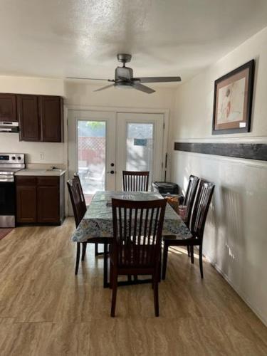 a dining room table and chairs in a kitchen at Sunny and Spacious, Hottub, Piano, Guitars, Fenced Yard, Pets Welcome, LGBT Friendly in Westminster