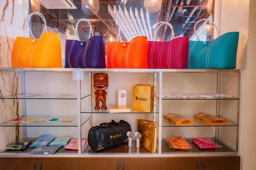 a display case with purses and handbags on display at Goldberry Lite Hotel in Iloilo City