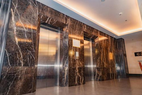 a lobby with a wall of black marble at Goldberry Lite Hotel in Iloilo City