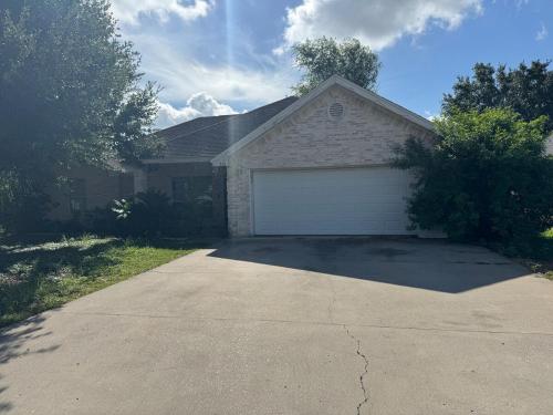 a house with a garage in a driveway at Cozy and close to everything in Alamo
