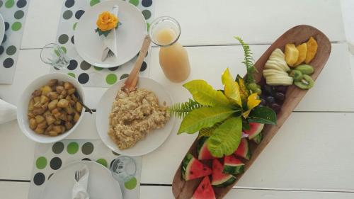 a table topped with plates and bowls of food at Villa Noria in Las Terrenas