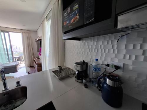 a kitchen counter with a coffee maker on it at Apartment Tower Luxury Home Palace a 100 mts Shopping del Sol con parking amplio in Asuncion