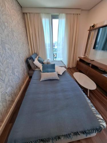 a living room with a large couch and a television at Apartment Tower Luxury Home Palace a 100 mts Shopping del Sol con parking amplio in Asuncion