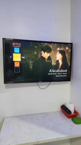 a flat screen tv hanging on a wall at For You Hotel in Ho Chi Minh City