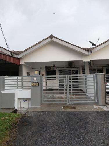 a white house with a parking lot in front of it at Homestay Kuala Selangor Islamic Friendly Only in Kuala Selangor