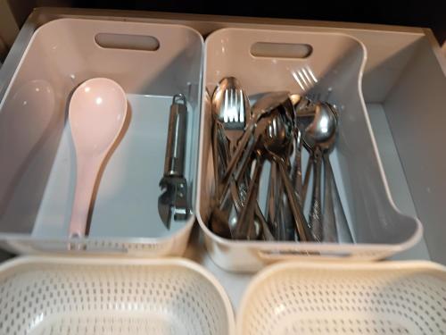 a lunch box with utensils in it at Homestay Kuala Selangor Islamic Friendly Only in Kuala Selangor