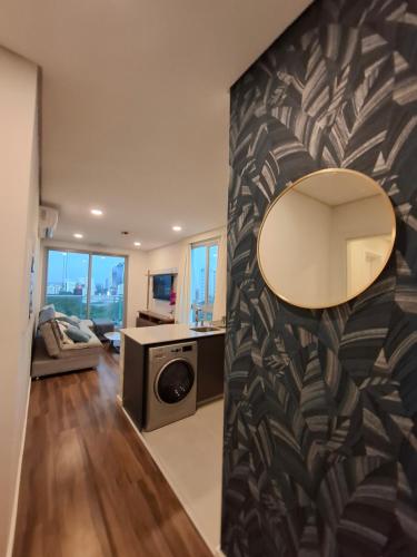 a living room with a large mirror on a wall at Apartment Tower Luxury Home Palace a 100 mts Shopping del Sol con parking amplio in Asuncion