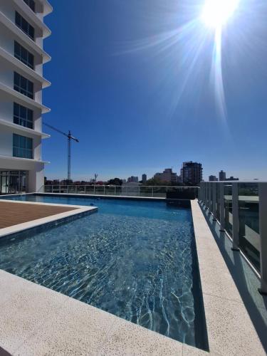 a swimming pool on the roof of a building at Apartment Tower Luxury Home Palace a 100 mts Shopping del Sol con parking amplio in Asuncion