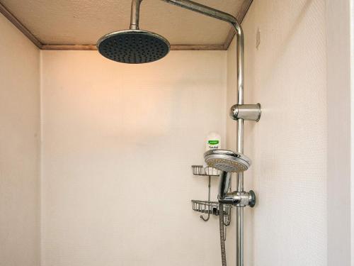 a shower in a bathroom with a shower head at 4 person holiday home in Haderslev in Haderslev