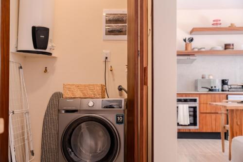 a washing machine in a room with a kitchen at Luxury Jungle Condos by Casago in Tulum