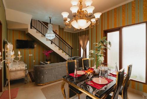 a living room with a table and a couch at Veeka Villa in Nusa Dua