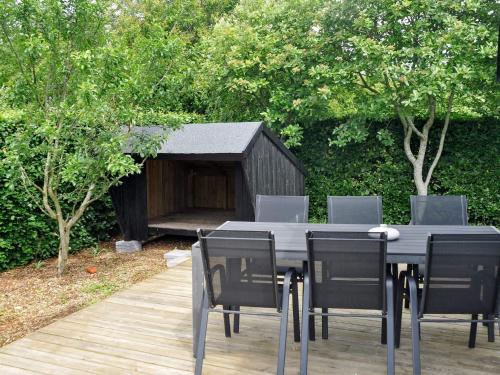 a black table and chairs and a dog house at 6 person holiday home in Struer-By Traum in Remmer Strand