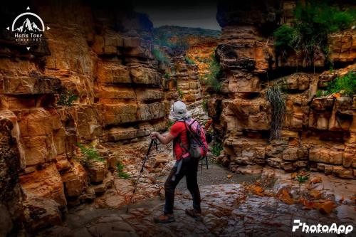 a person with a backpack walking through a canyon at Veni Vedi in Vedi