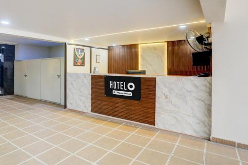a hotel lobby with a hotel sign on a counter at Hotel O Ananthpur Formerly TR Residency in Anantapur