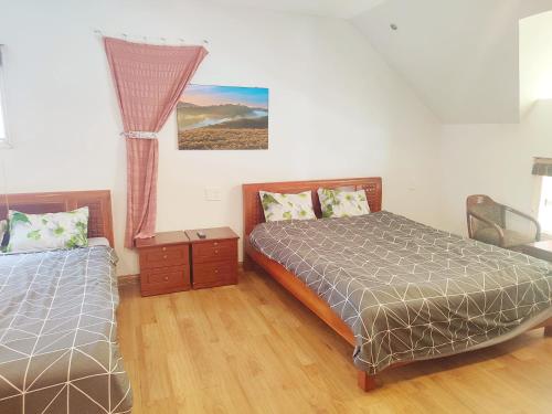 a bedroom with two beds and a window at Tiên Hoa Sơn Villa in Da Lat