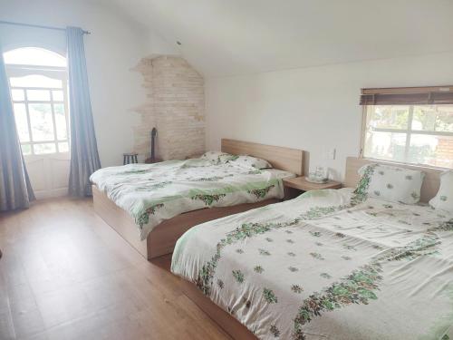 a bedroom with two beds and a fireplace at Tiên Hoa Sơn Villa in Da Lat