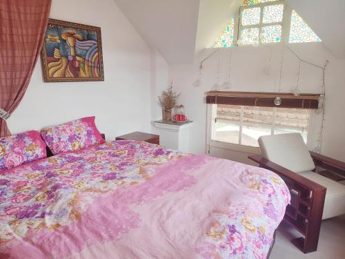 a bedroom with a large bed and a window at Tiên Hoa Sơn Villa in Da Lat