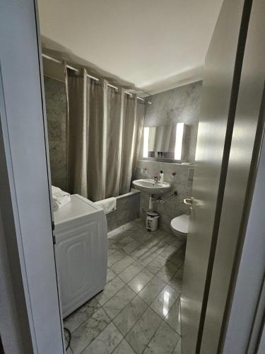 a bathroom with a toilet and a sink at Les Galeries Marval in Neuchâtel