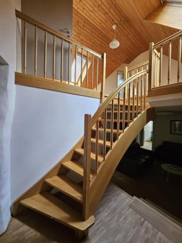 a wooden staircase in a house with a wooden ceiling at Les Galeries Marval in Neuchâtel