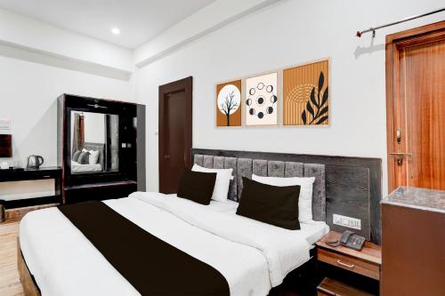 a bedroom with a large bed in a room at Palette Hotel and Resort Sarnath Temple in Varanasi