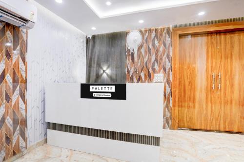 a lobby with a gate sign on the wall at Palette Hotel and Resort Sarnath Temple in Varanasi