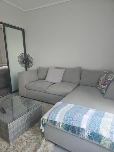 a living room with a couch and a table at Waterfall Apartments Waterfall Cres in Midrand